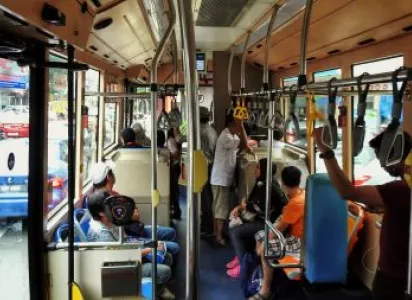 Commuters seated inside a bus, some looking out the windows, illustrating daily public transit use in Clayton.