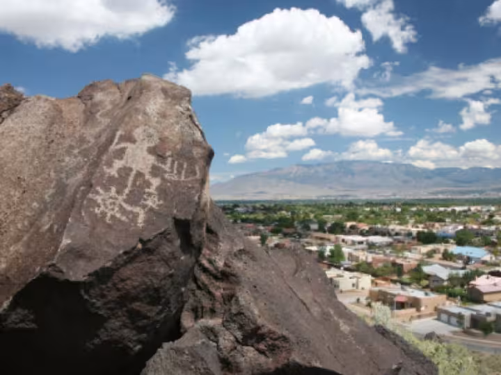 Image taken from behind a rock, with the city in the background.