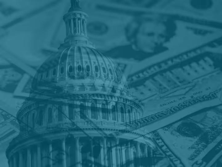 Dollar bills layered over the White House