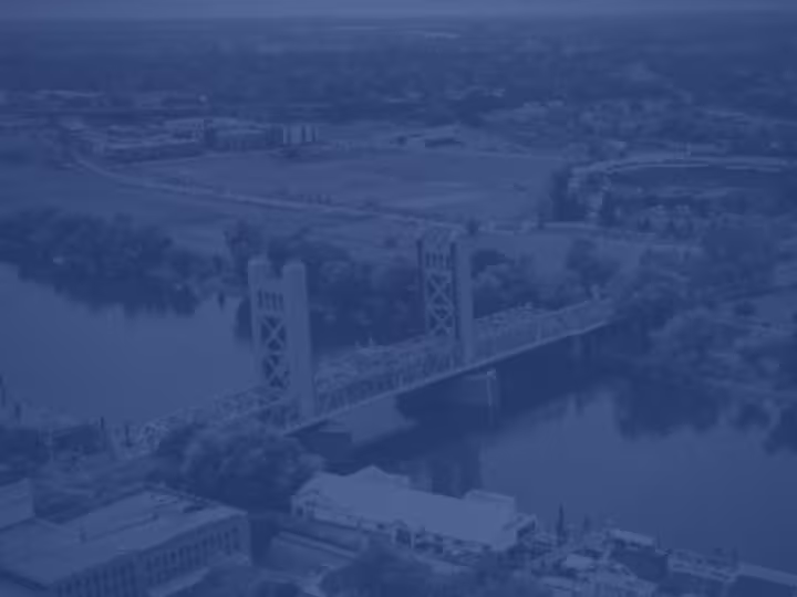 Aerial view of Sacramento, with a prominent bridge crossing the river.