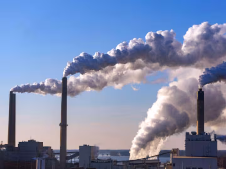 Image of factory chimneys polluting the air.