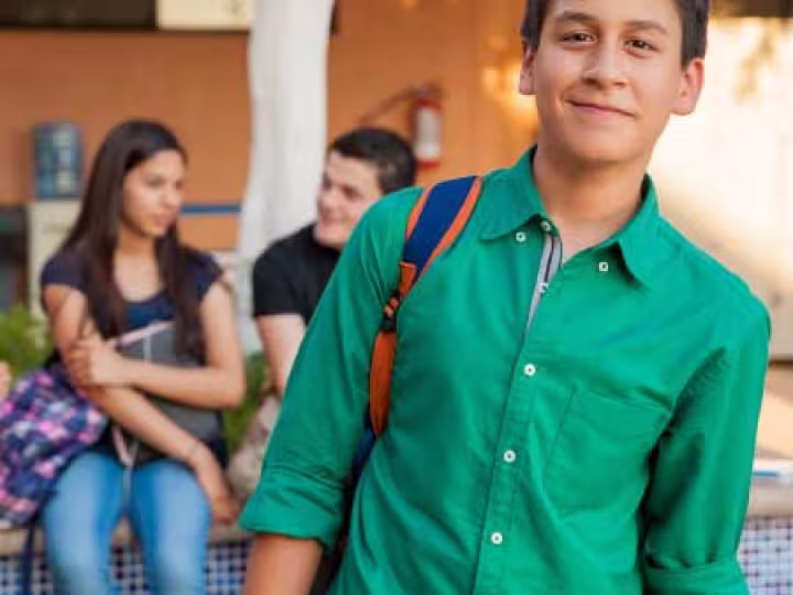 Boy at school with a backpack.
